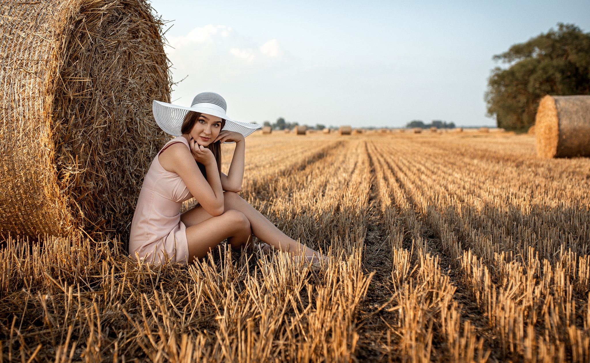Девушка возле снопа сена