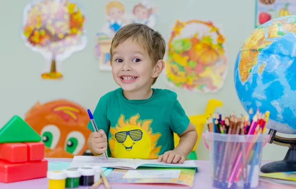 Картинка солнце, радость, улыбка, эмоции, стол, стена, краски, учеба, ребенок, мальчик, карандаши, малыш, футболка, ручка, школа, …